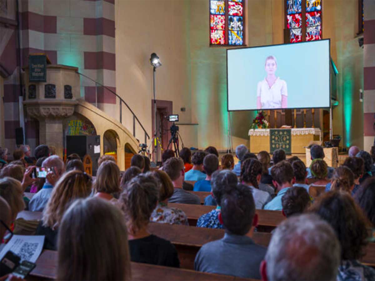 Visitors and attendees during the AI-powered worship service in Fürth, Germany,