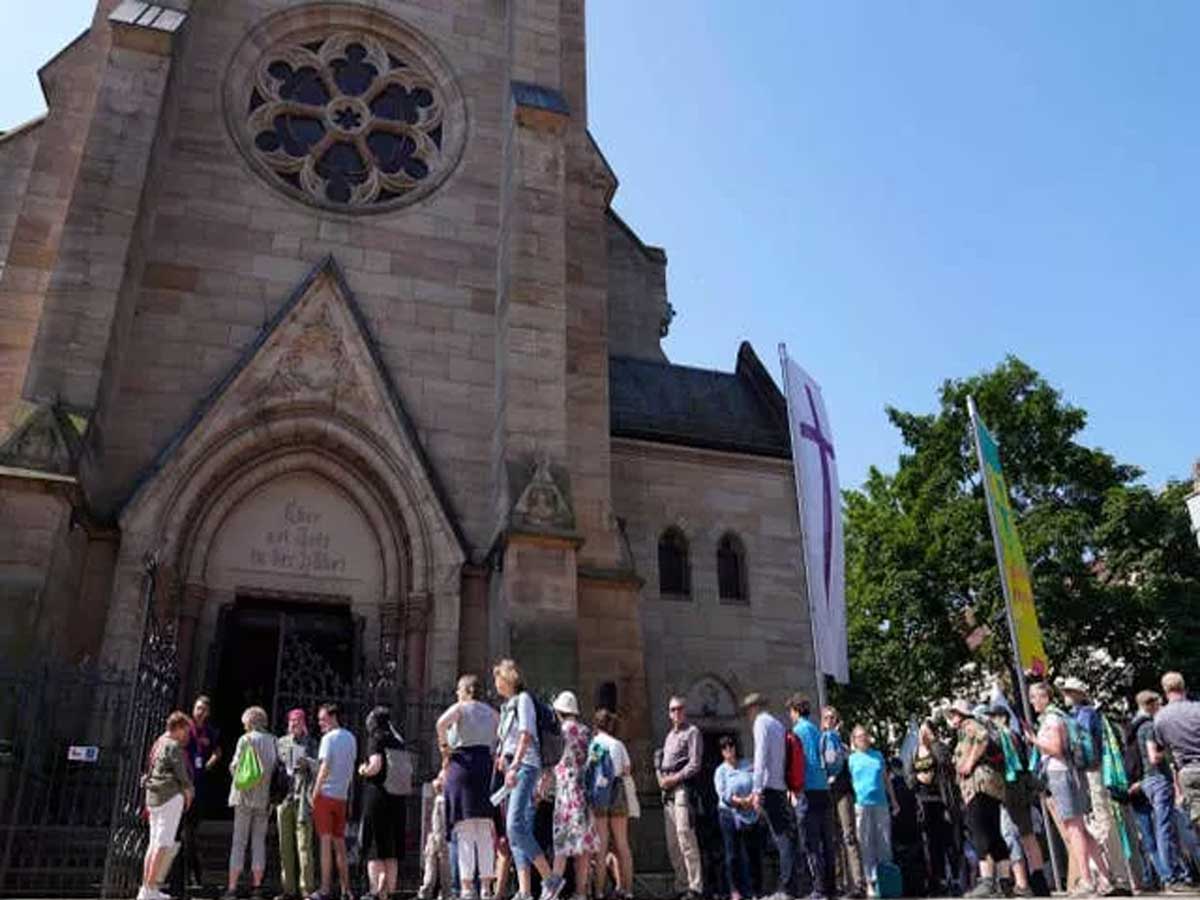 People queue for the church service in Nuremberg Germany 