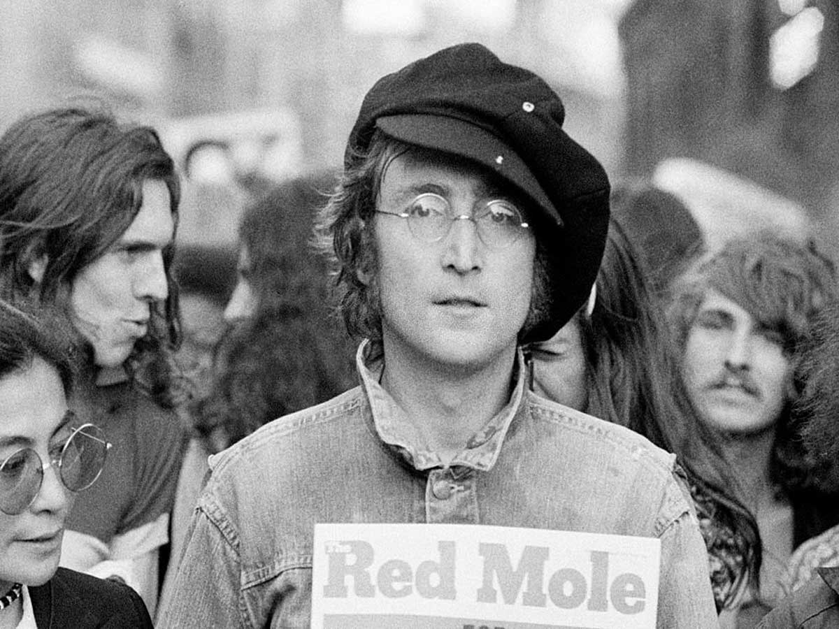 Portrait of British musician John Lennon (1940 - 1980) (center) and his wife, artist and musician Yoko Ono (extreme left) as they attend an unspecified rally in Hyde Park, London, England, 1975.